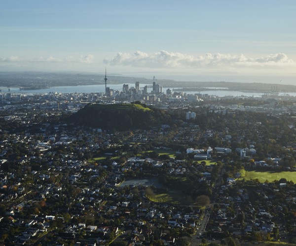 Aerial view of Mt Eden with Auckland Harbour Bridge in background